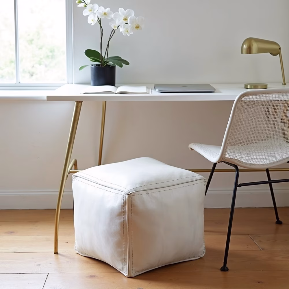 Minimalist space featuring square leather pouf