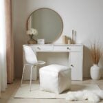 White square leather pouf ottoman for extra seating near beige armchairs in contemporary living room