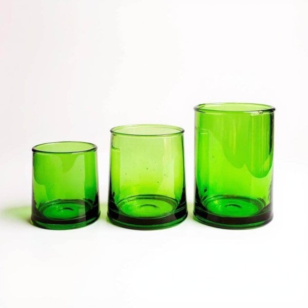 Three emerald moroccan wine glasses in small, medium, and tall sizes lined up against a clean white background.