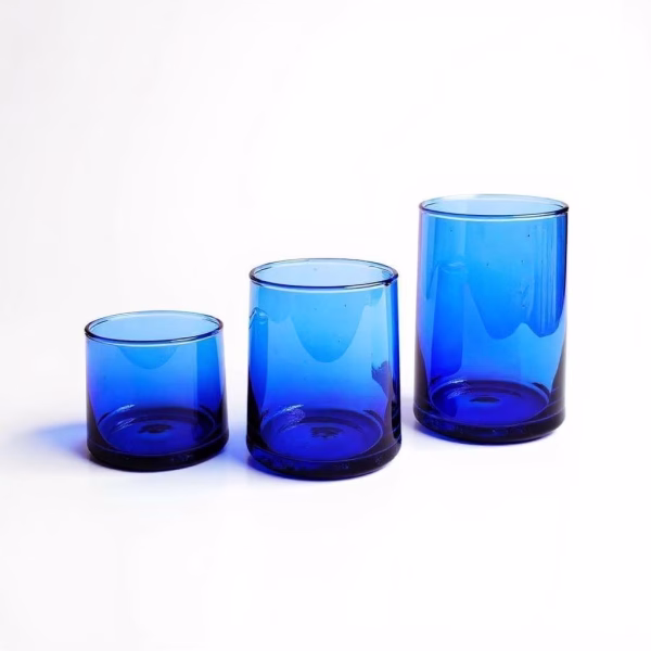 Three sapphire moroccan wine glasses of varying heights showcased on a pure white backdrop.
