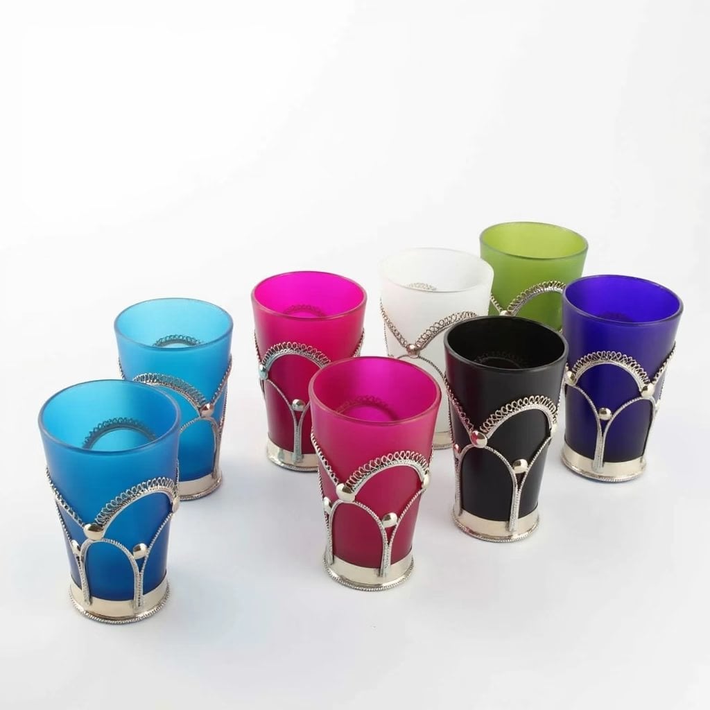 Detail of frosted colorful tea glasses wrapped in ornate Moroccan silver filigree wire-wrapping