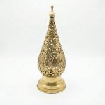 Isolated product view of a handcrafted Moroccan brass bedside lamp featuring a teardrop shape and detailed metal cutouts on a white background.