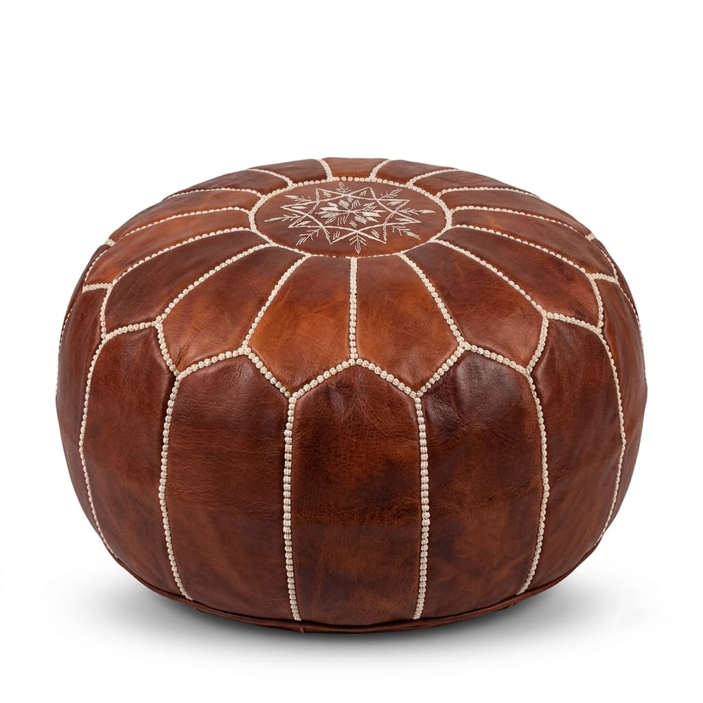 brown-leather-round-ottoman-white-background Brown leather round ottoman with embroidered geometric star pattern and hand-stitched central medallion
