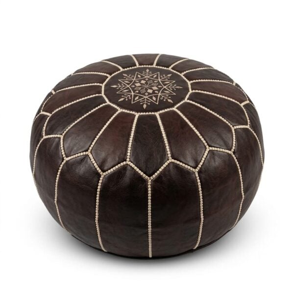 A dark brown leather round pouf with traditional geometric stitching, isolated on a clean white background.