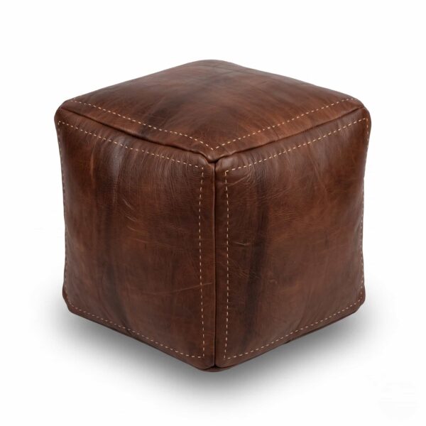 A studio product shot of a dark brown square leather ottoman isolated on a clean white background.