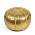 Gold leather round pouf isolated on a white background showing handcrafted Moroccan-inspired stitching and metallic gold leather finish.