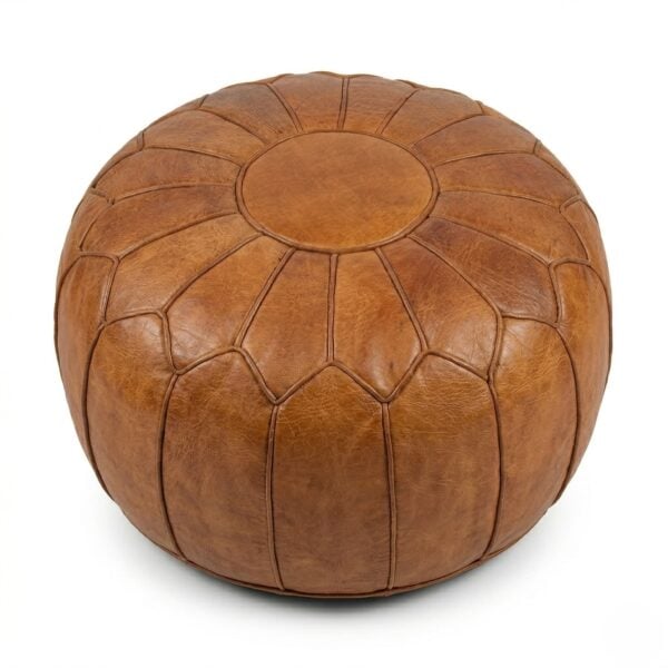 A high-quality tan round ottoman pouf made of genuine Moroccan leather, featuring a classic panel design on a white background.