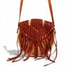 Handmade circle straw bag with rust macramé overlay and leather fringe - boho crossbody purse with adjustable strap
