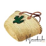 Bottom view of handwoven straw beach bag displaying woven palm leaf craftsmanship and structure