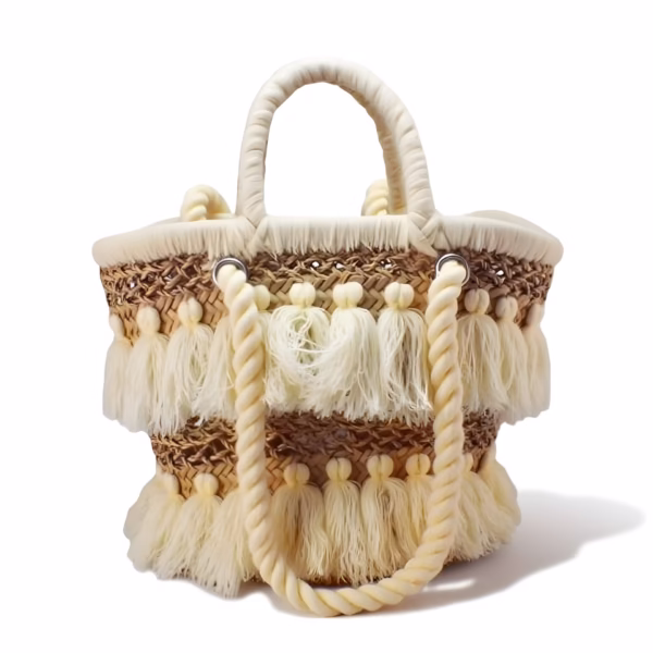 Front view of cream tassel straw bag on white background