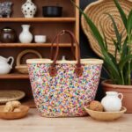 Handwoven Sequin Straw Bag on rustic shelf beside pottery, rainbow confetti market basket