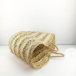 Handwoven straw basket bag interior opening view showing natural woven construction and depth