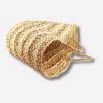 Side view of handwoven straw basket bag showing striped pattern