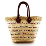 Rainbow sequin straw bag with brown leather handles and handwoven herringbone weave pattern on white background