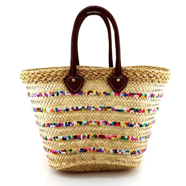 Rainbow sequin straw bag with brown leather handles and handwoven herringbone weave pattern on white background