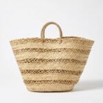 Handwoven straw basket bag with alternating herringbone and open lattice weave bands and straw-wrapped handles on a white background
