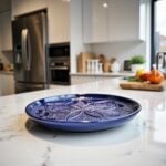 Navy blue geometric ceramic plate on kitchen counter, hand-engraved floral mandala design 22cm