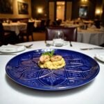 Blue geometric ceramic plate with gourmet food plating, hand-engraved relief pattern fine dining