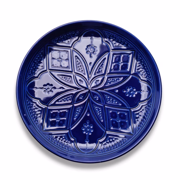 Detailed view of blue moroccan style plates featuring traditional geometric engravings