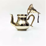 Side view of brass teapot showing spout detail"