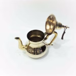 Interior view of brass teapot with lid open