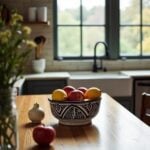 Large ceramic serving bowl with Zwak pattern filled with fresh apples in modern farmhouse kitchen