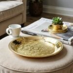Overhead view of mirror-polished round brass tray with scalloped borders and geometric star
