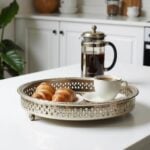 Silver tray with feet serving croissants and coffee on white kitchen counter for Moroccan breakfast