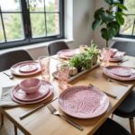 Pink geometric ceramic plates table setting with matching bowls and glassware, hand-engraved design