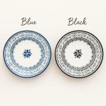 Blue and black hand-painted ceramic plates with Moroccan Atlas Bloom pattern side by side comparison