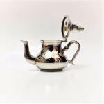 Interior view of silver teapot showing lid design