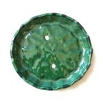 Handmade green Tamegroute ceramic plate with scalloped edge showing mottled emerald glaze and artisan craftsmanship