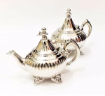 Set of ribbed silver teapots in different sizes