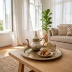 Minimalist hammered silver teapot on a traditional brass tray in an organic modern living space