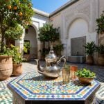 Detail of minimalist hammered silver teapot showing hand-textured band and flat circular base