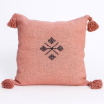 Coral Moroccan boho cushion with playful corner tassels