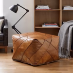 Modern leather ottoman pouf in home office setting