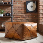 Square pouf with diamond stitching against brick wall