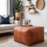 Brown square leather ottoman near home office desk with black chair and minimal decor