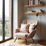 Embroidered cotton pillow covers with botanical floral motif in beige armchair by window