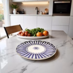 Blue ceramic plate painting displayed on marble kitchen counter with fresh vegetables