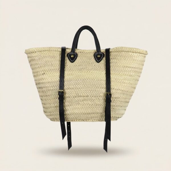 Convertible Straw Backpack Tote with black leather backpack straps and brass buckle hardware on an off-white background