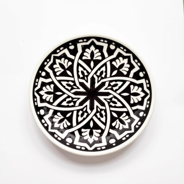 Black and white geometric ceramic serving dish 25cm featuring hand-painted mandala star pattern on cream base