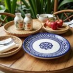 Blue ceramic plates with traditional geometric design on rustic wooden table with wicker baskets and fresh cherries