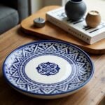 Blue ceramic plates with detailed geometric borders and floral center medallion on natural wood table setting