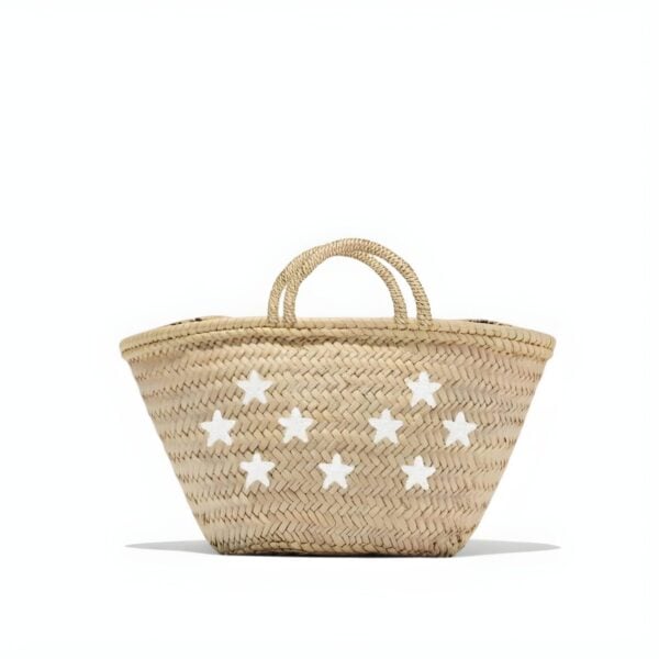 Carry artisan Moroccan craftsmanship with this handwoven palm leaf tote featuring scattered white star appliqués by artisan Dounia. (122) ✓