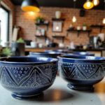 Navy blue geometric ceramic bowls with intricate hand-carved chevron designs in café