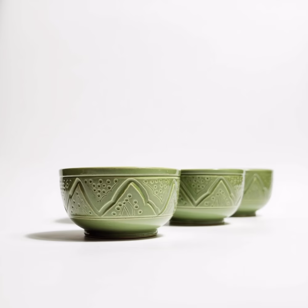 Set of 4 hand-engraved ceramic bowl collection in green, yellow, blue and white displayed in various settings