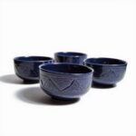 Yellow geometric ceramic bowl set with hand-engraved traditional patterns on wooden table