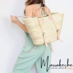Convertible straw backpack with light tan leather straps displayed as stylish beach tote bag